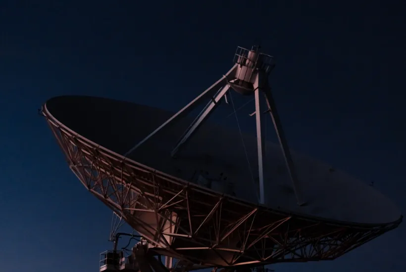 Satellite dish against a dark sky, representing communication technology related to cryptocurrency and finance.